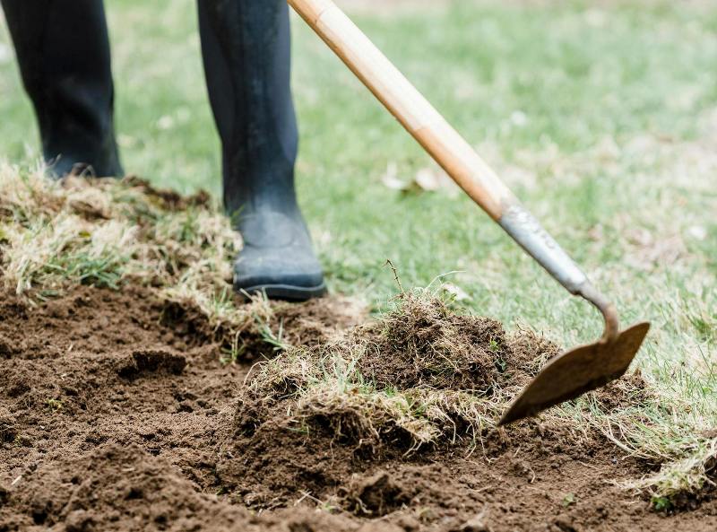 Filling low spots and aerating soil for drainage
